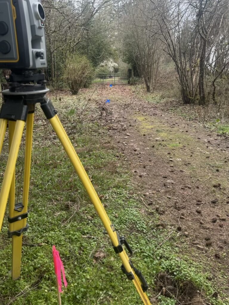Surveying instrument on a tripod at an outdoor work site